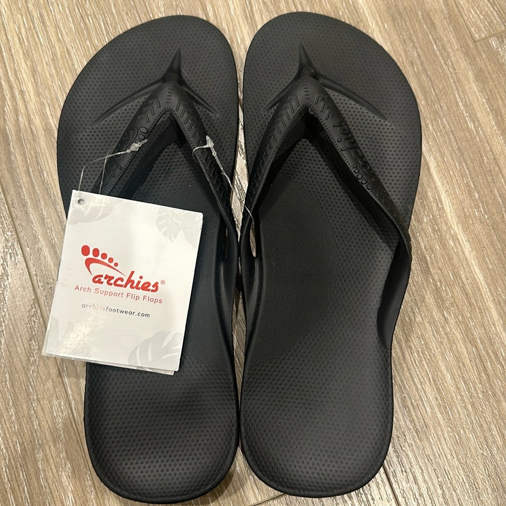 Archie’s black flip flops